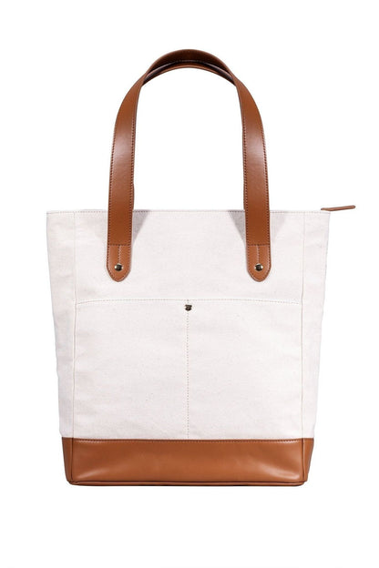 White tote bag with brown leather accents on a white background