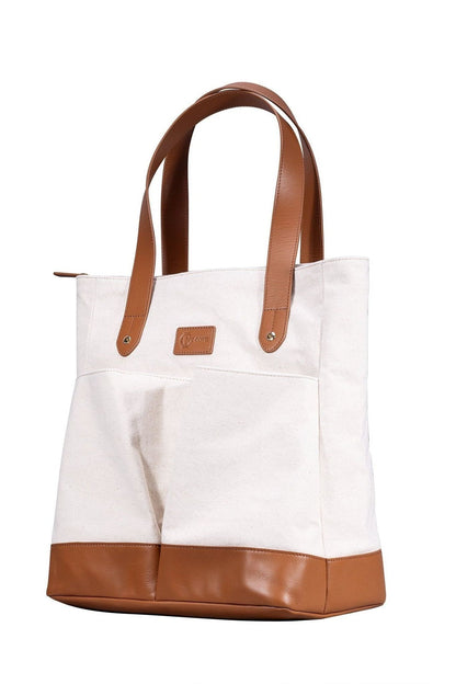 White tote bag with brown leather accents on a white background