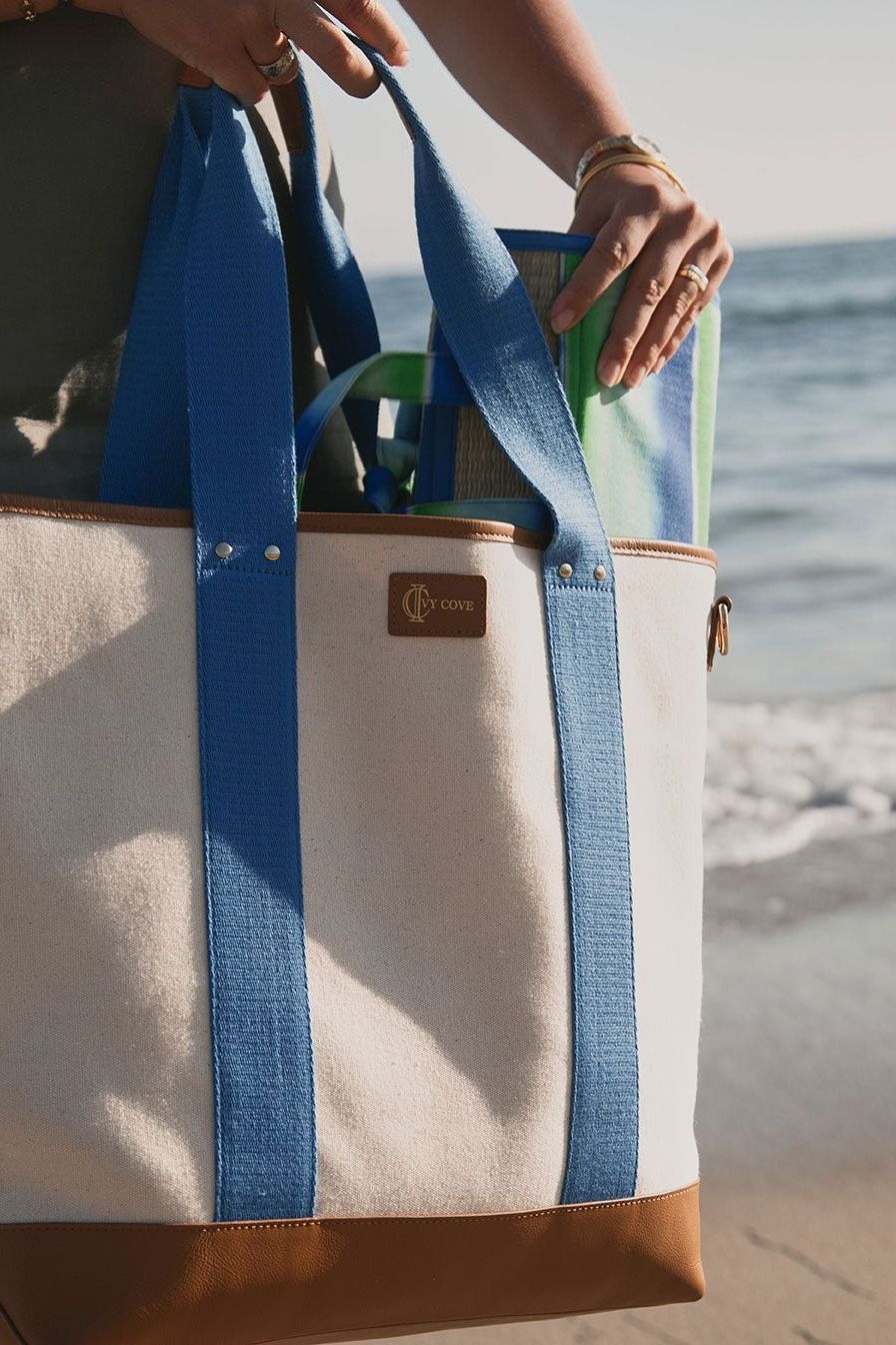 Ivy Cove Saltwater Tote styled as a beach bag — luxury canvas tote with leather trim in Cobalt Stripe