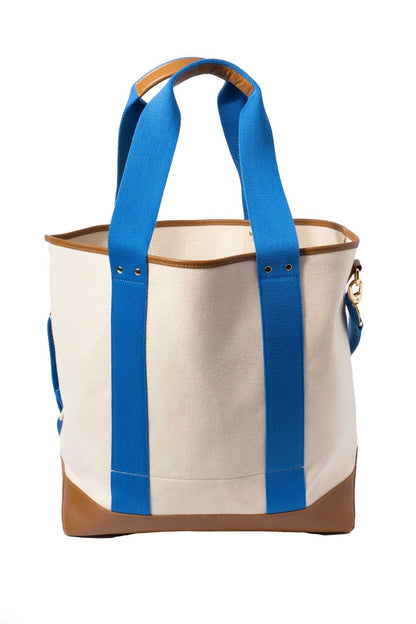 Side view of Ivy Cove Saltwater Tote showing structured leather bottom and Cobalt stripe handles